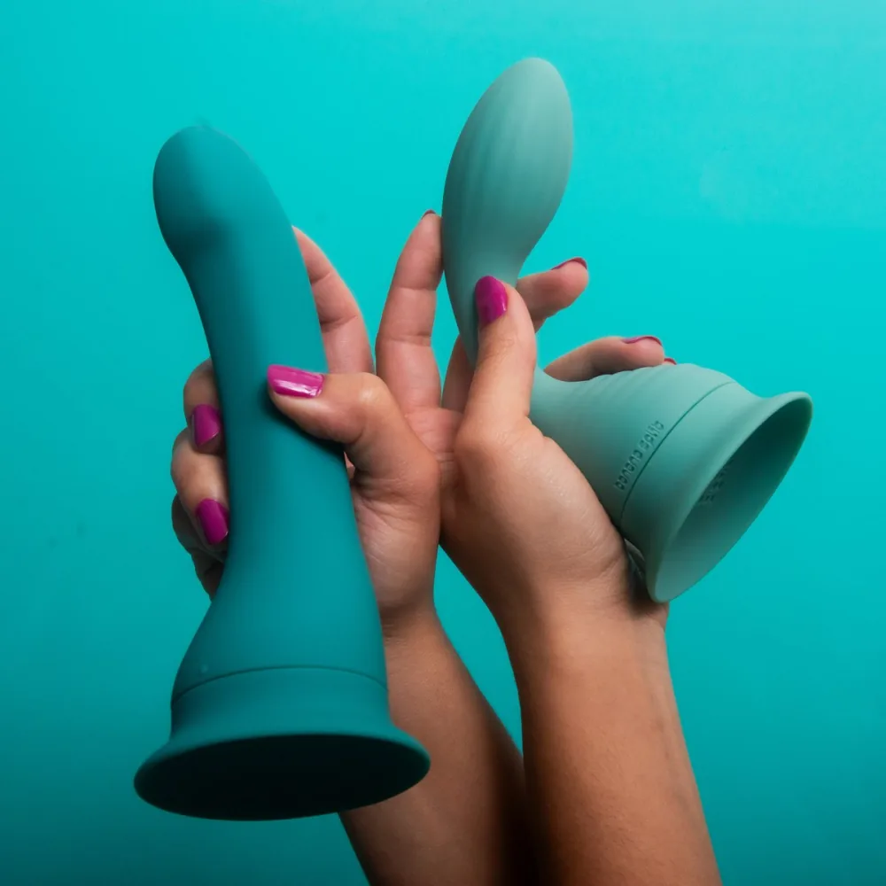 The two ends of The Split vibrating strap-on, held in two hands